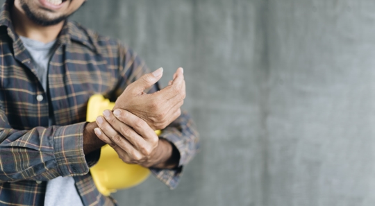 Worker handing wrist due to pain